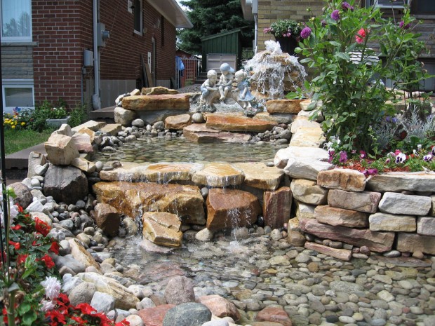 Natural-Stone-Waterfall-Pond-Design-with-Kid-Statues-for-Home-Garden-Landscaping-Ideas
