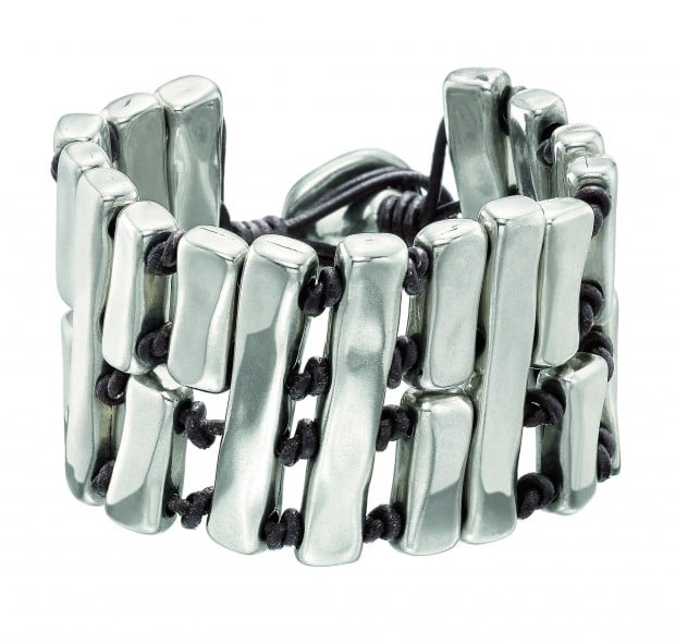 Wide bracelet consisting of various silver-plated metal rectangular blocks separated from each other by brown leather knots.