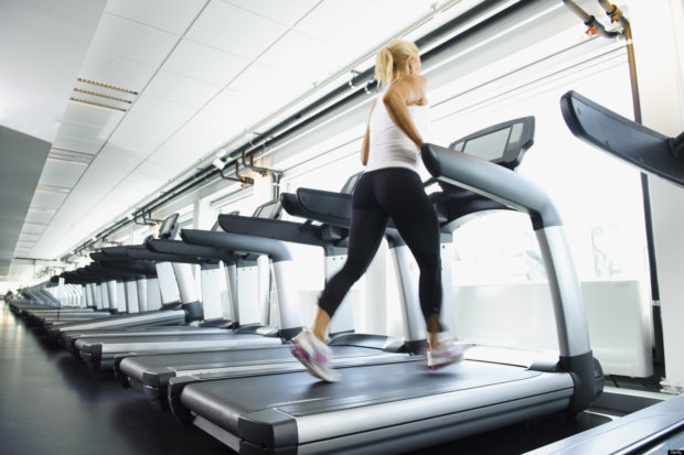 Woman exercising on treadmill in gym