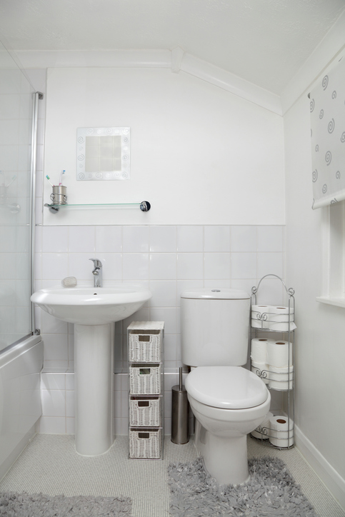 in an older house, a small bathroom has been updated with a light white modern clean feel