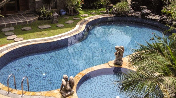 Grassed pool surrounds are even cheaper and very easy to maintain