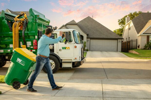 Residential Customer with Waste Management Recycling Bin and Waste & Recycling Pickup Truck