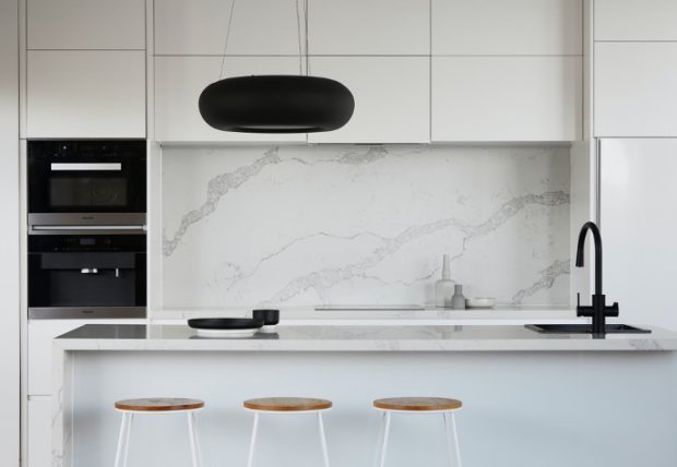 White marble kitchen with black tapware