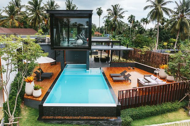 Private tropical swimming pool and gym near luxury villa. Sunny summer travel vacation, palm trees jungle Private tropical swimming pool and gym near luxury villa. Sunny summer travel vacation, palm trees jungle