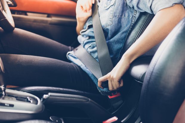 Asian woman fastening seat belt in the car, safety concept Asian woman fastening seat belt in the car, safety concept
