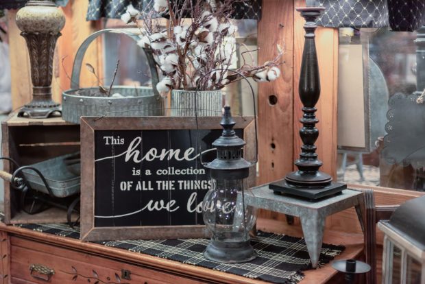 Rustic wood and galvanized home decor display with a sign that says “This home is a collection of all the things we love”