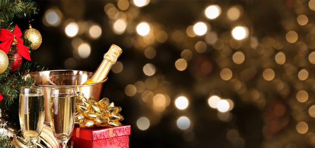 Christmas or New Year’s Eve. Champagne and Presents over Black Background. Celebration Christmas or New Year’s Eve. Champagne and Presents over Black Background. Celebration