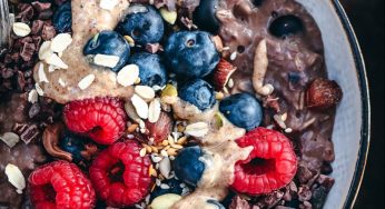 Porridge with sesame and coconut milk, topped with berries and seeds