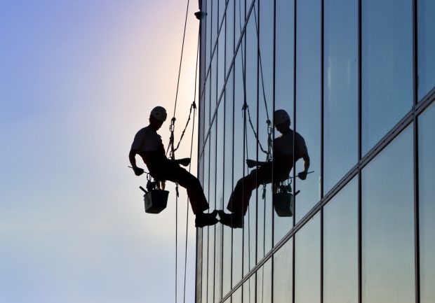 Window cleaner silhouette in the sunset